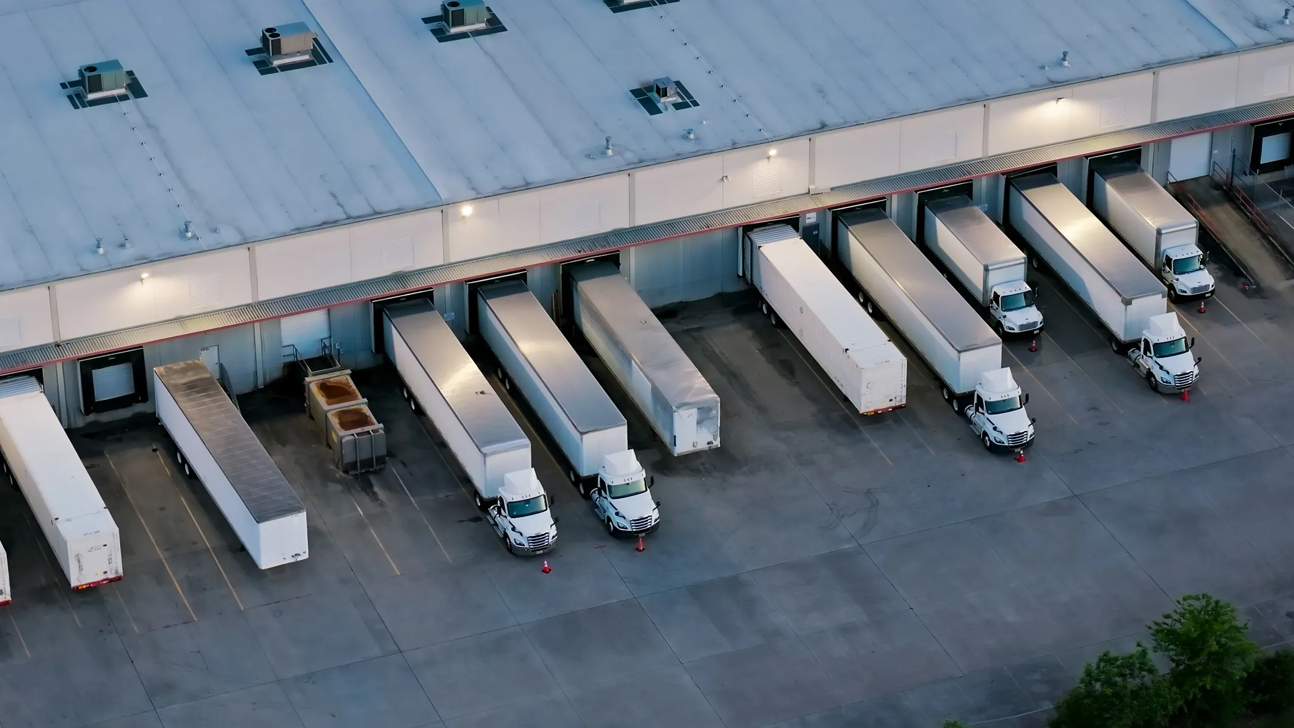 Birdseye image of trucks at a logistics facility.