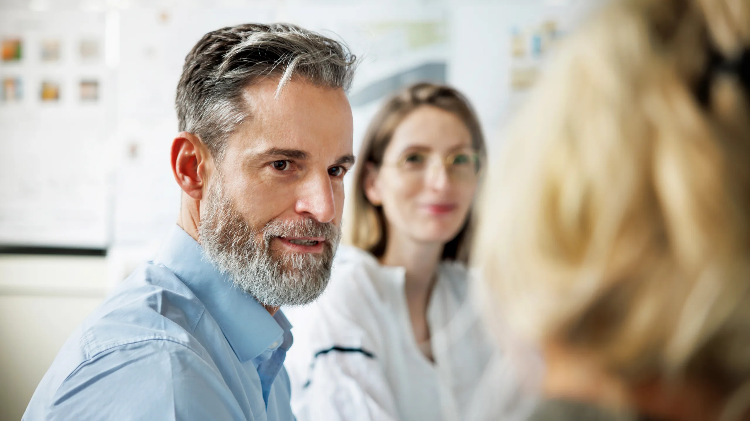 Architect listening attentively during strategic team meeting
