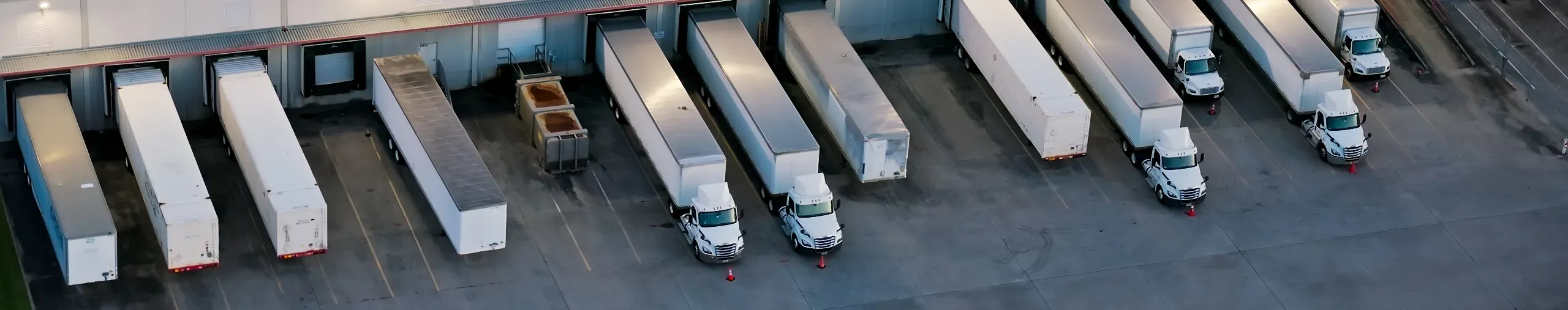 Birdseye image of trucks at a logistics facility.